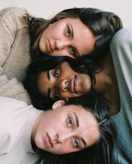 three women in assorted-color tops