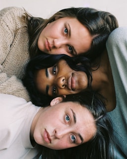 three women in assorted-color tops
