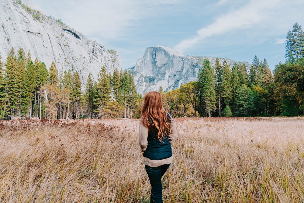 woman standing on brown field