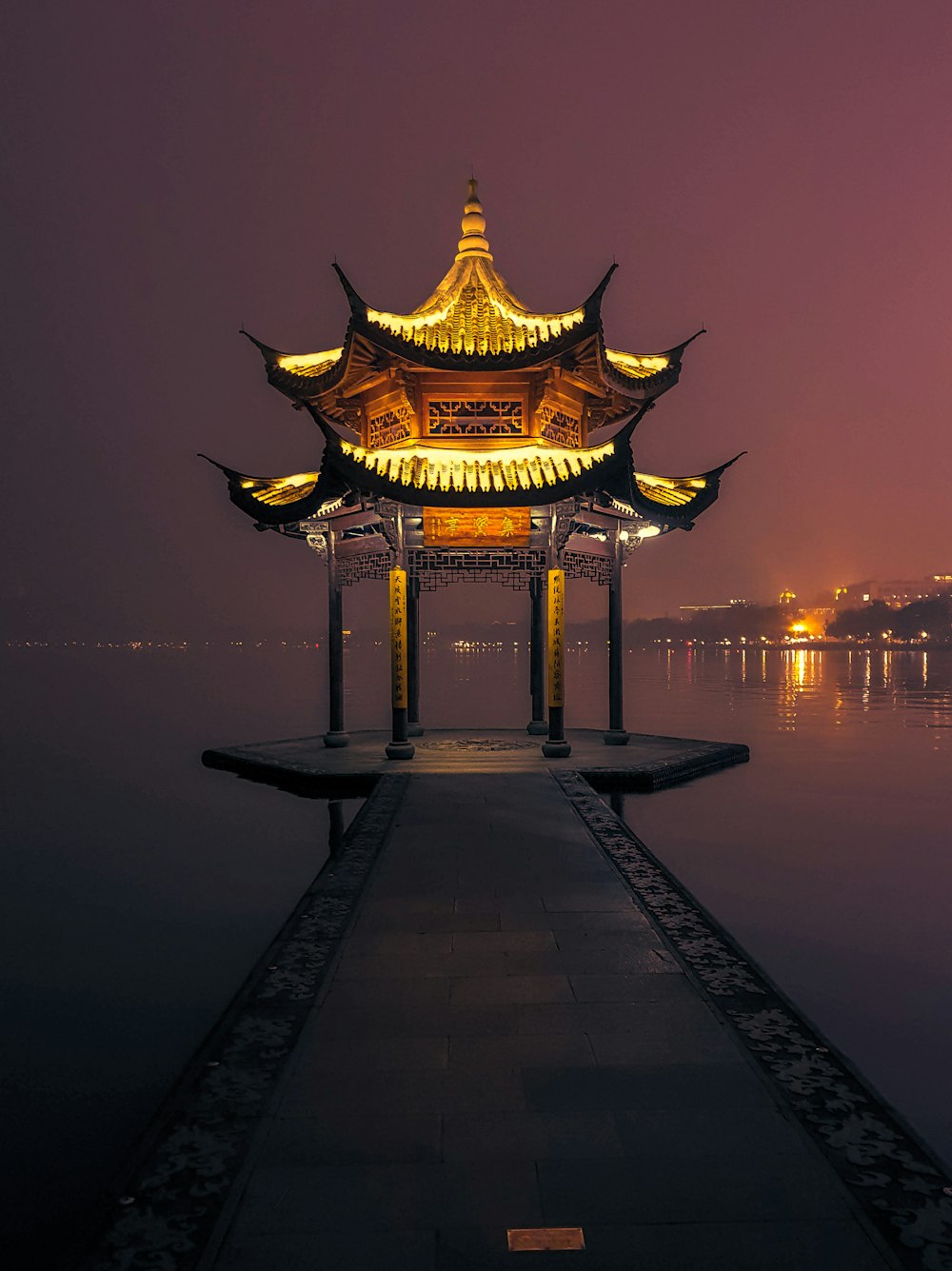 brown temple beside calm body of water