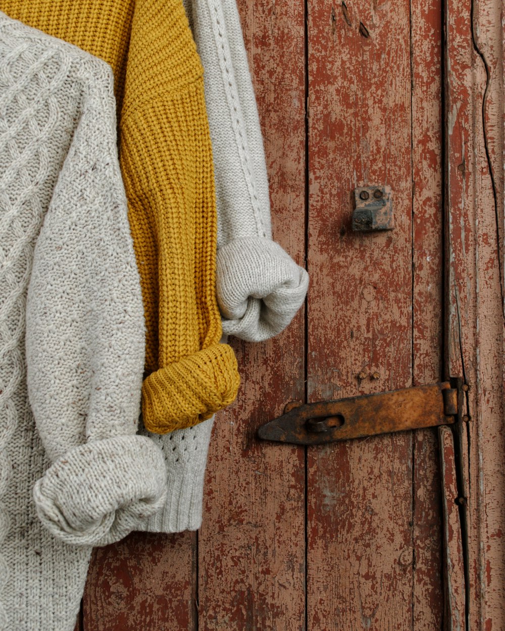 yellow, beige, and grey knitted shirts