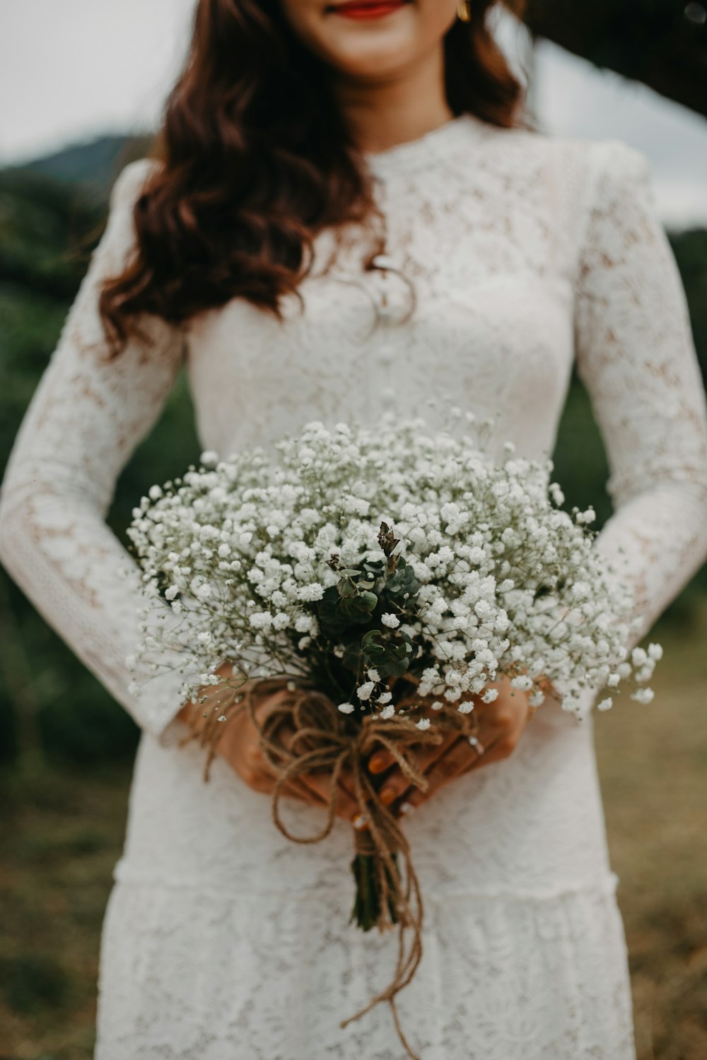 woman in wedding dress holding bouquet