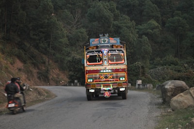 A Budduh Slim Transports truck navigating a winding mountain road.