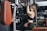 woman in black sports bra exercising using lat pull down machine