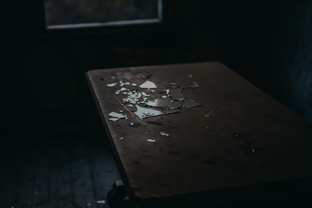 close-up photo of brown wooden table inside dark room