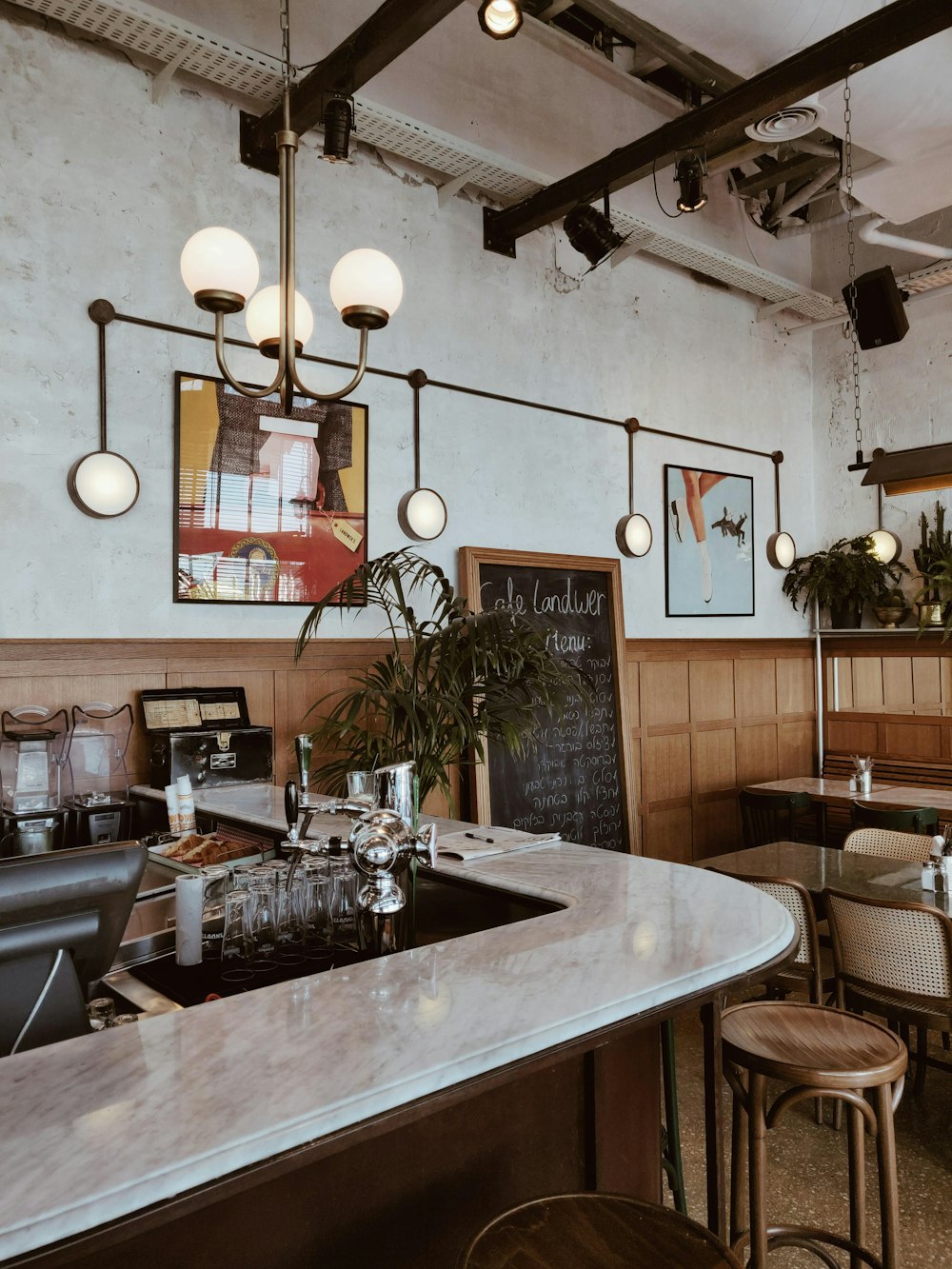 white pendant lamp over white marble bar table