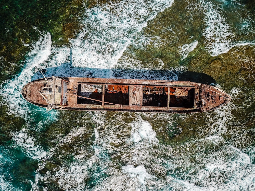 aerial view of brown wooden row boat on shore