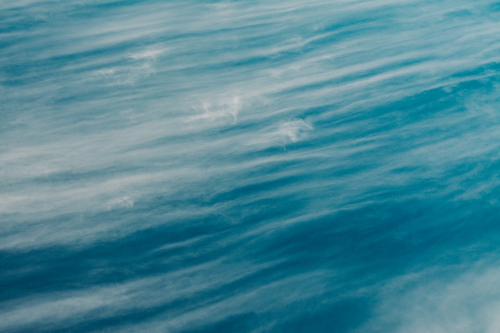 a man riding a surfboard on top of a wave