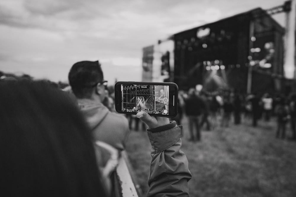 grayscale photo of person holding smartphone