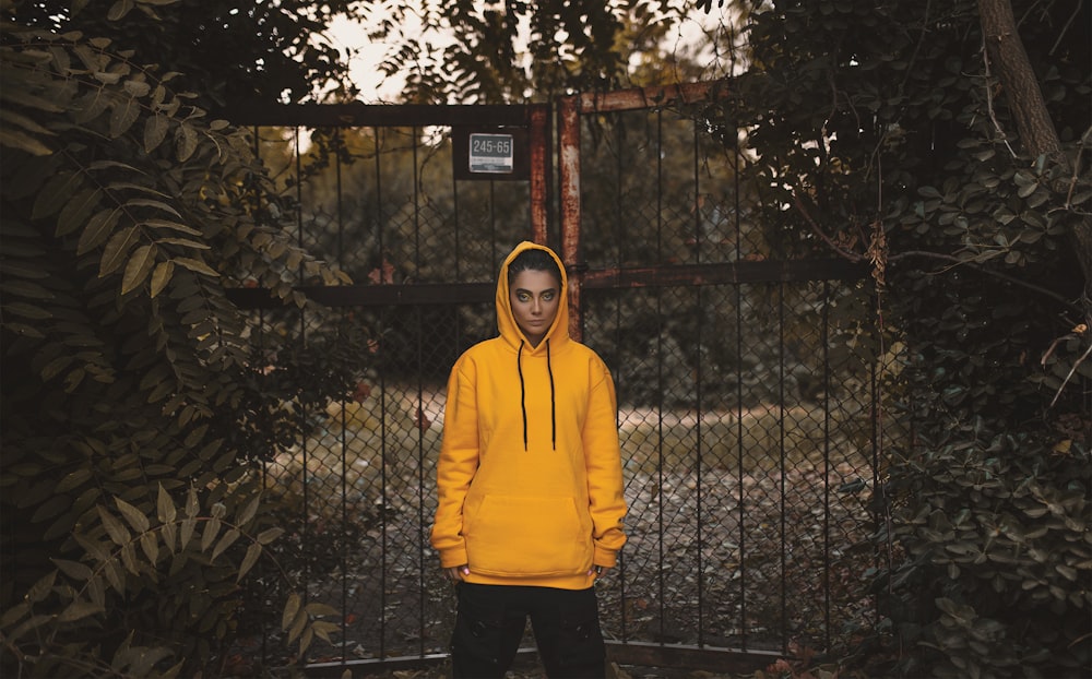 hooded man standing beshing gate