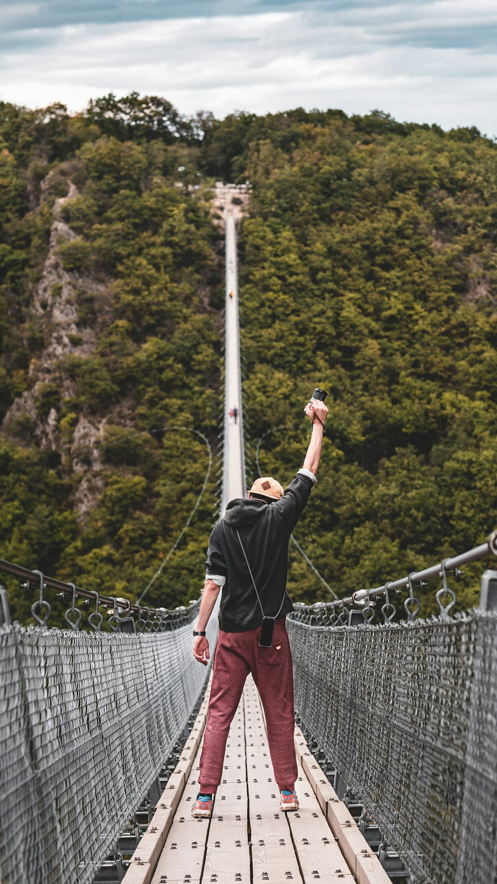 man standing on bridge during daytime