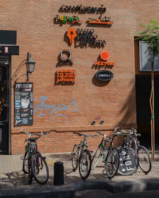 bicycles parked in front of brown-bricked building