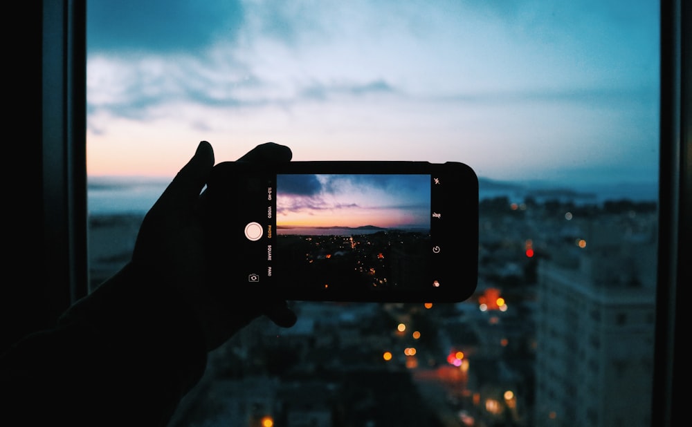 person taking photo of buildings