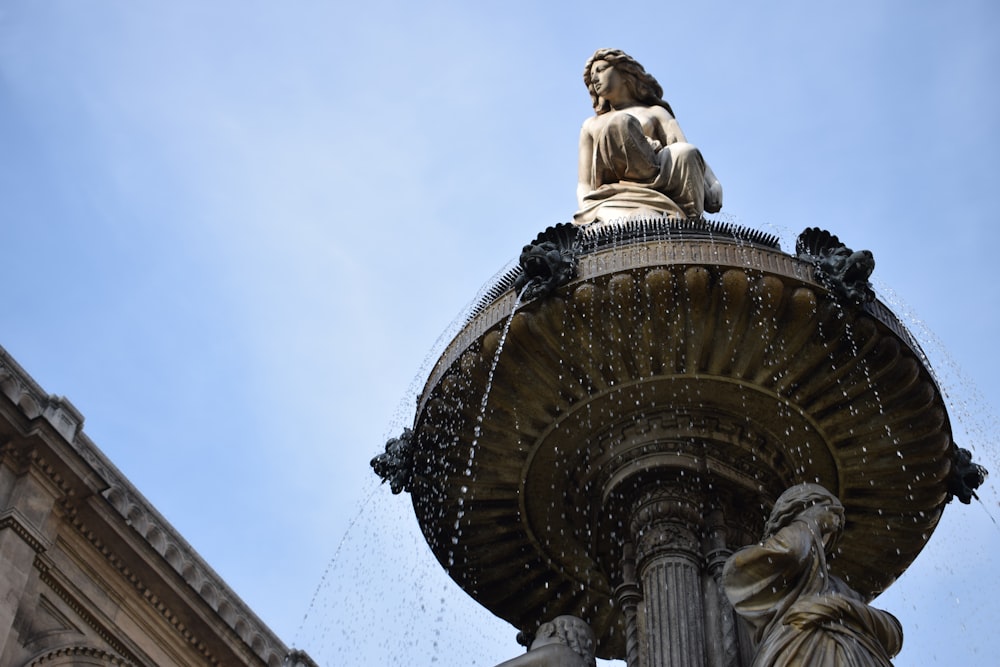 woman water fountain statue during daytime