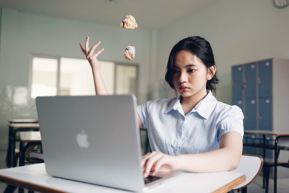 woman tossing crampled paper