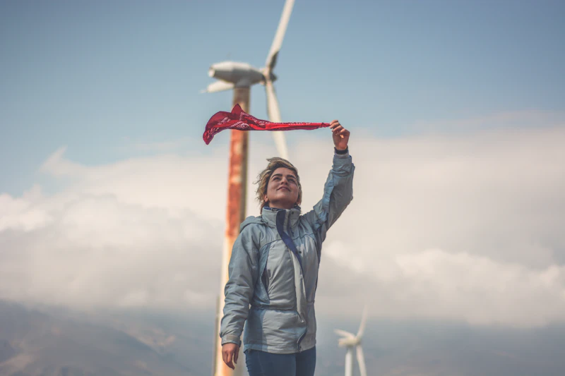 Worker walking among wind turbines spread across an open landscape