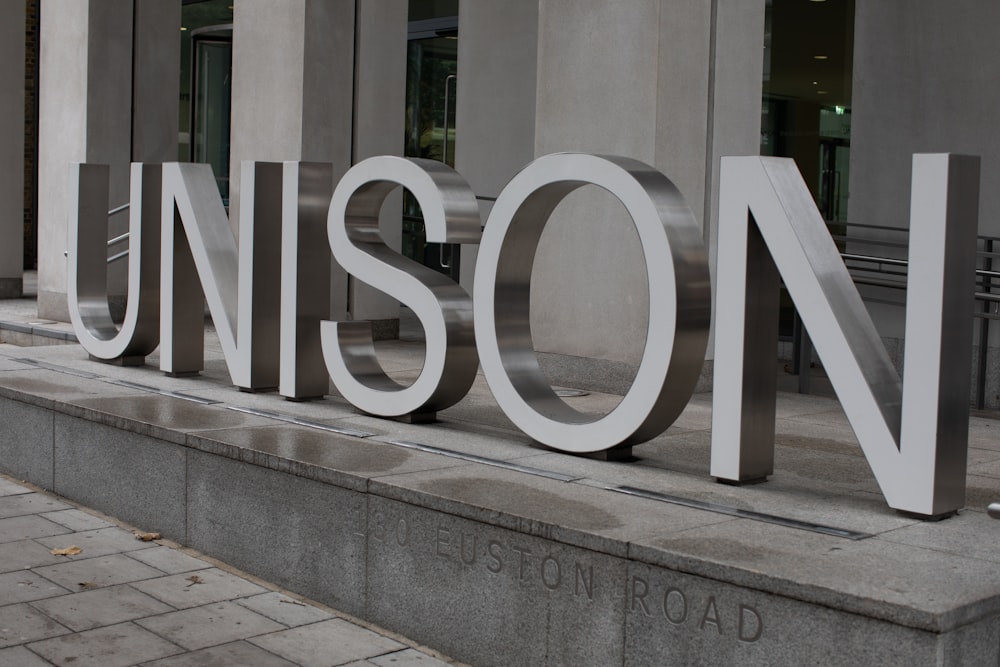 grayscale photography of Unison sign