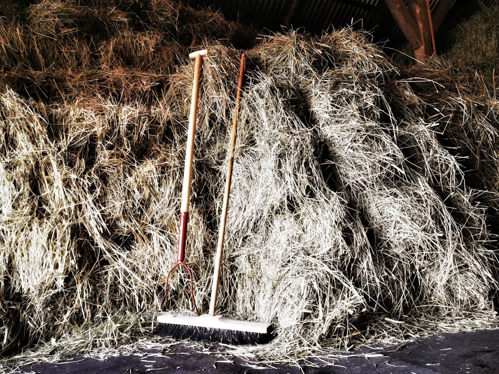 two brown hay rakes