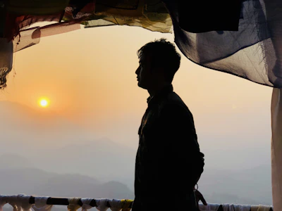 A serene photo of a woman standing at sunrise, symbolizing new beginnings and hope.