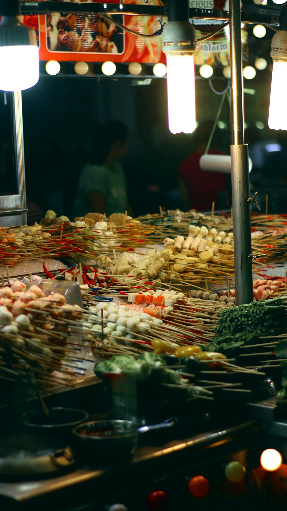 people standing near food stall during night time