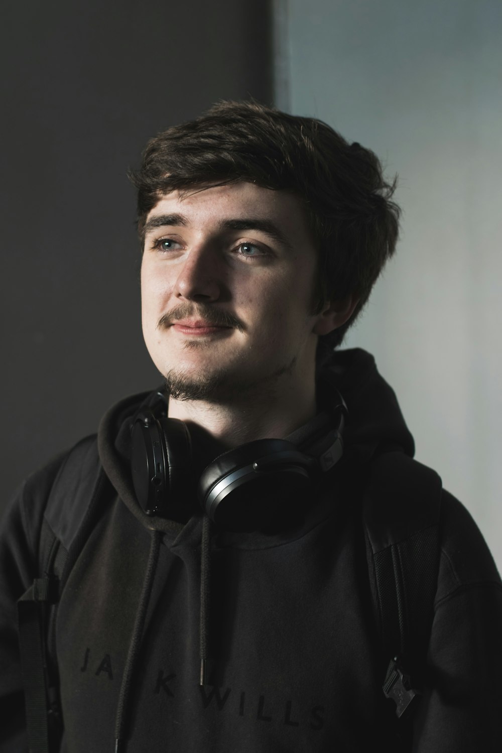 a man wearing headphones and a black hoodie