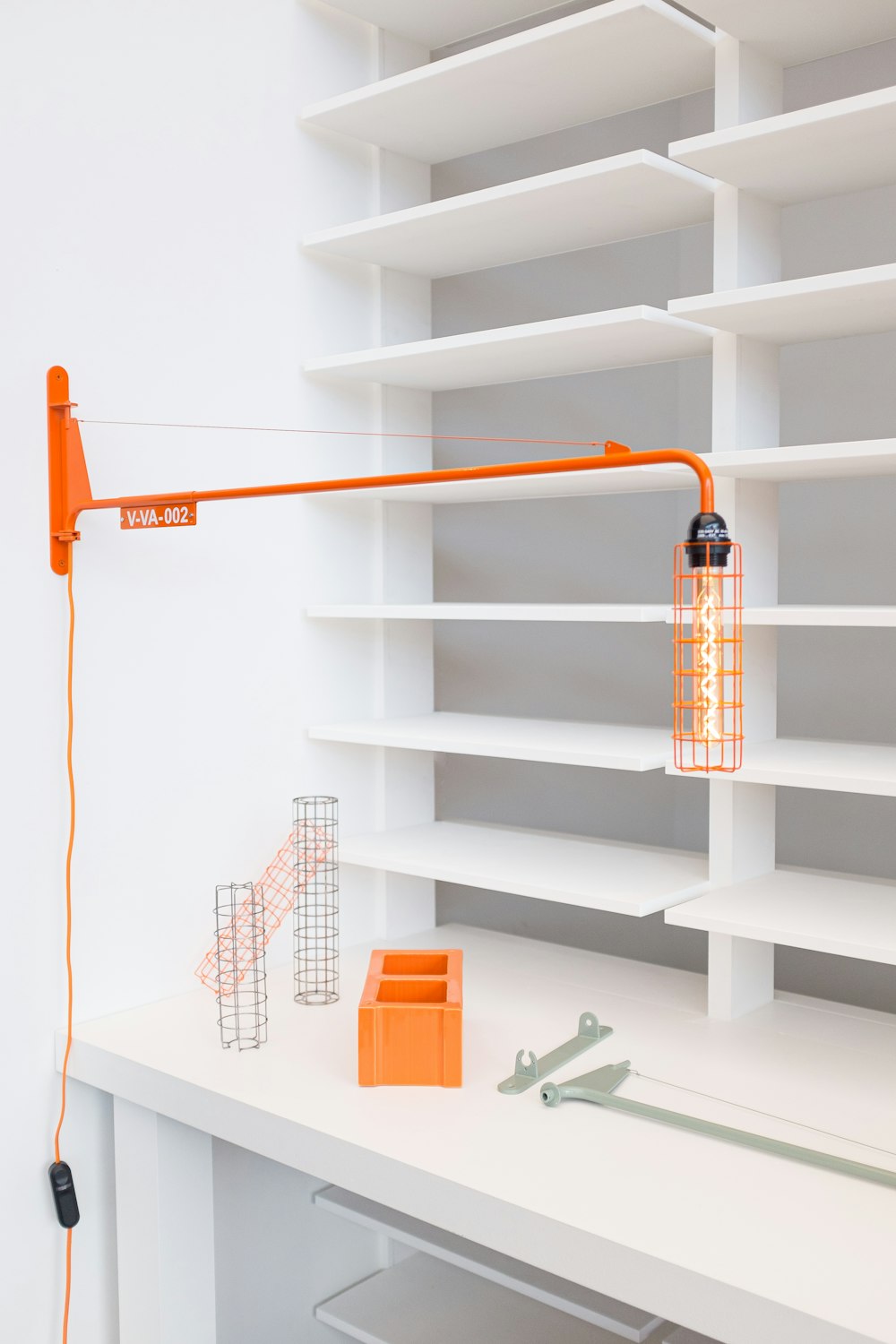 orange wall lamp near empty wall shelves