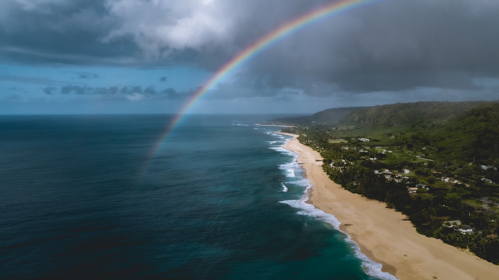 rainbow above sea during daytime