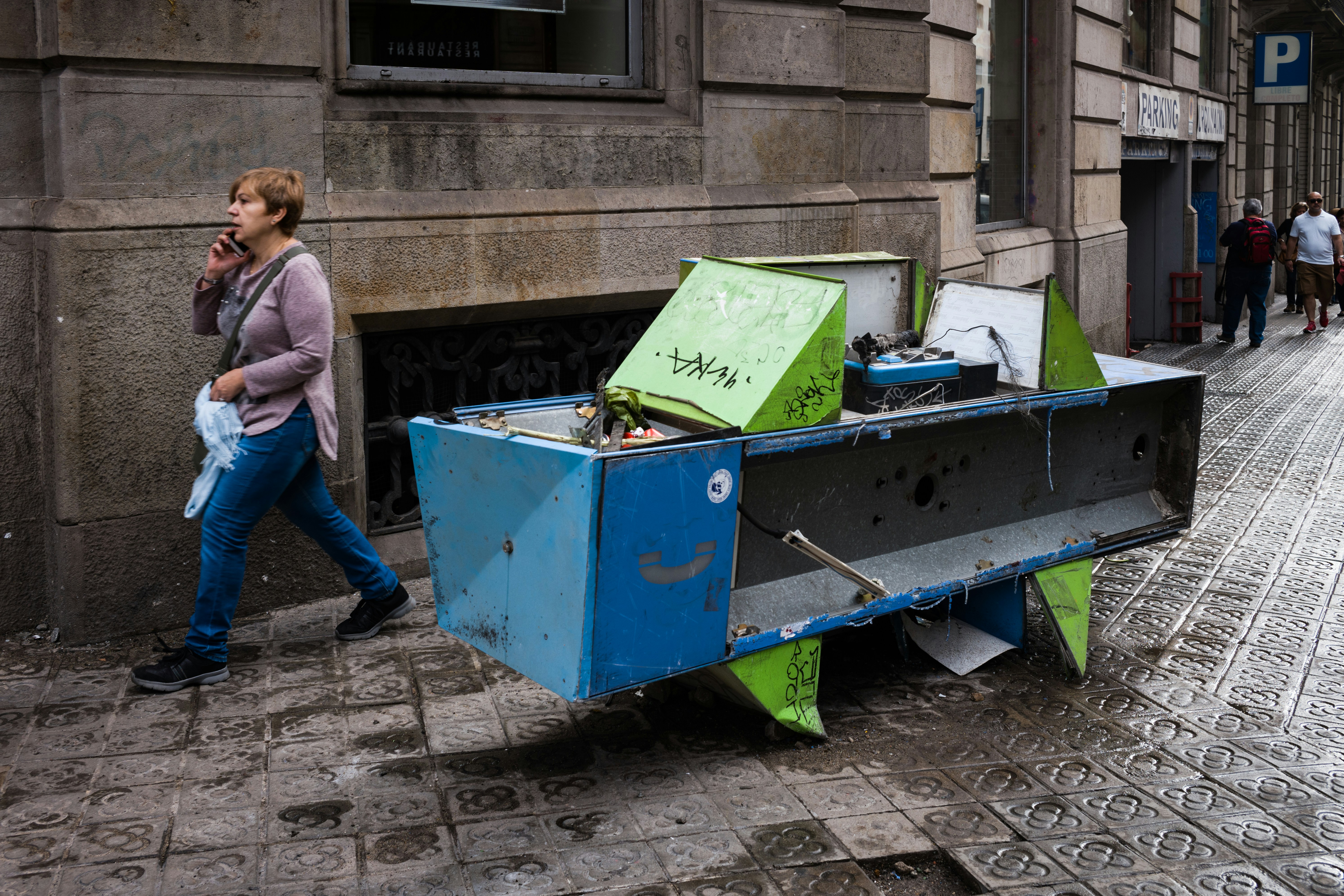 woman walking beside concrete building