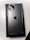 A sleek smartphone with a metallic finish is placed on top of its box. The back showcases three camera lenses and the iconic logo in the center, highlighting its premium design.
