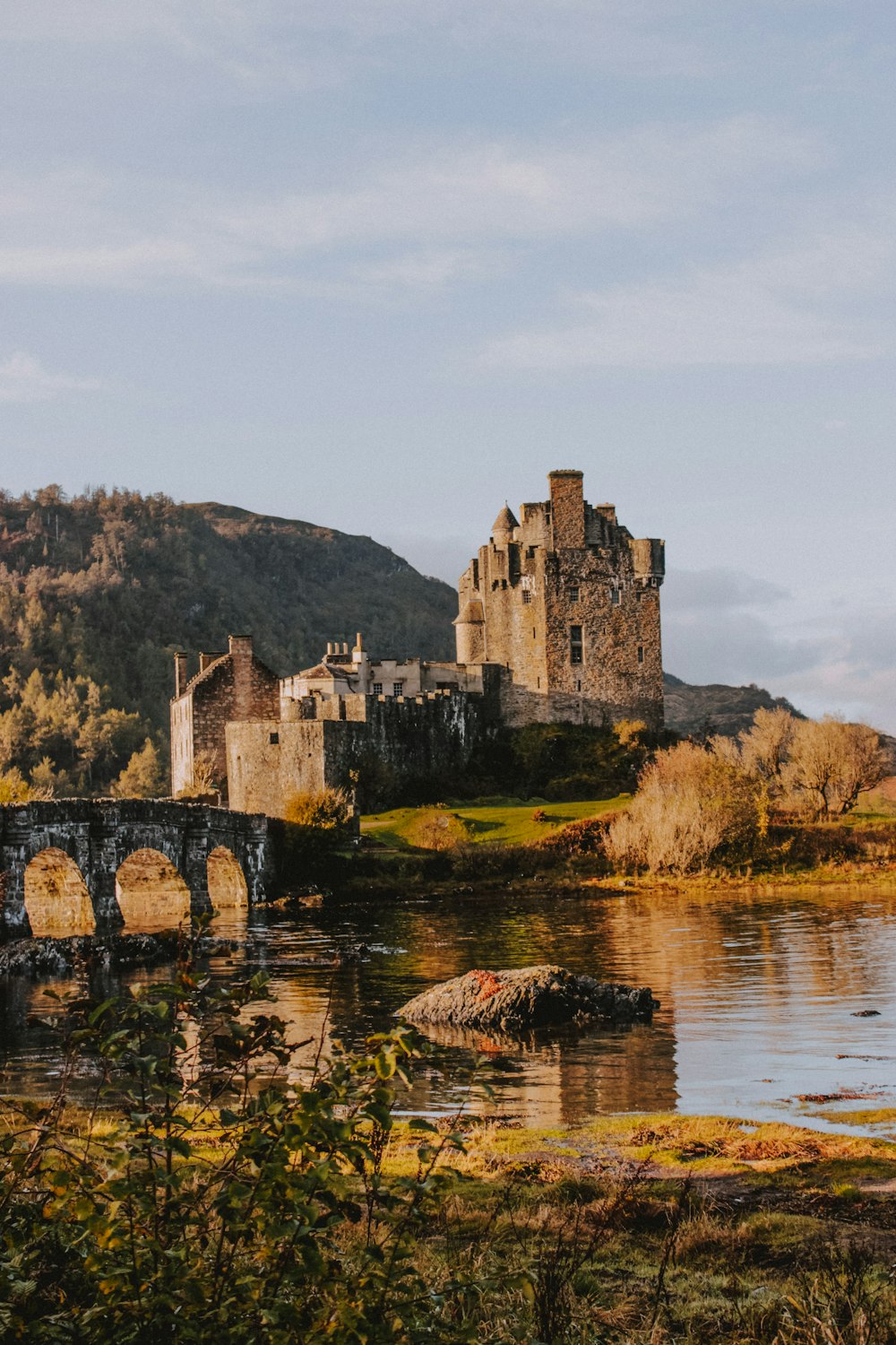 gray castle beside river during daytime