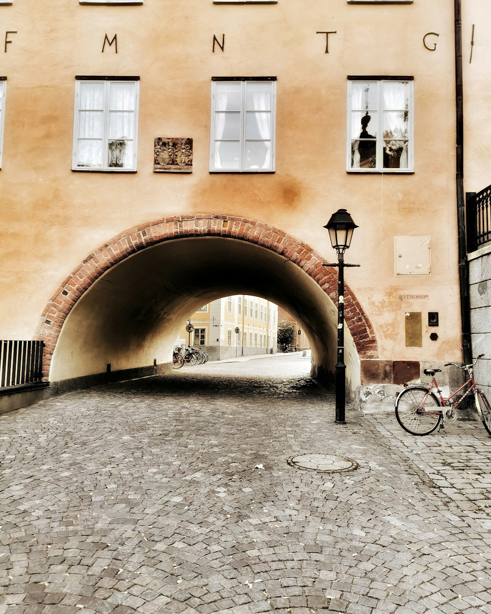 brown arch tunnel beside lamp post