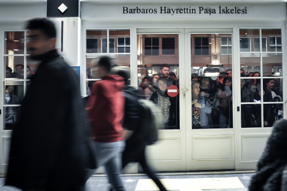 people walking beside Barbaros Hayrettin Pasa Iskelesi buildng