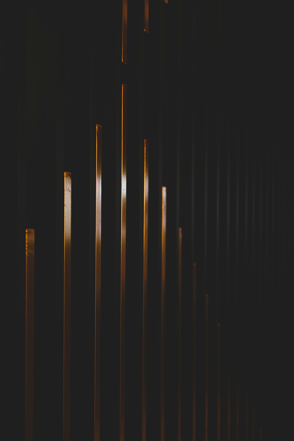 a row of metal poles in a dark room
