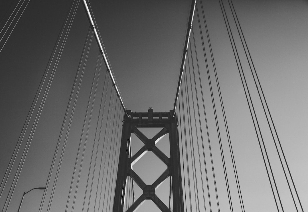 grayscale photography of self-anchored suspension bridge