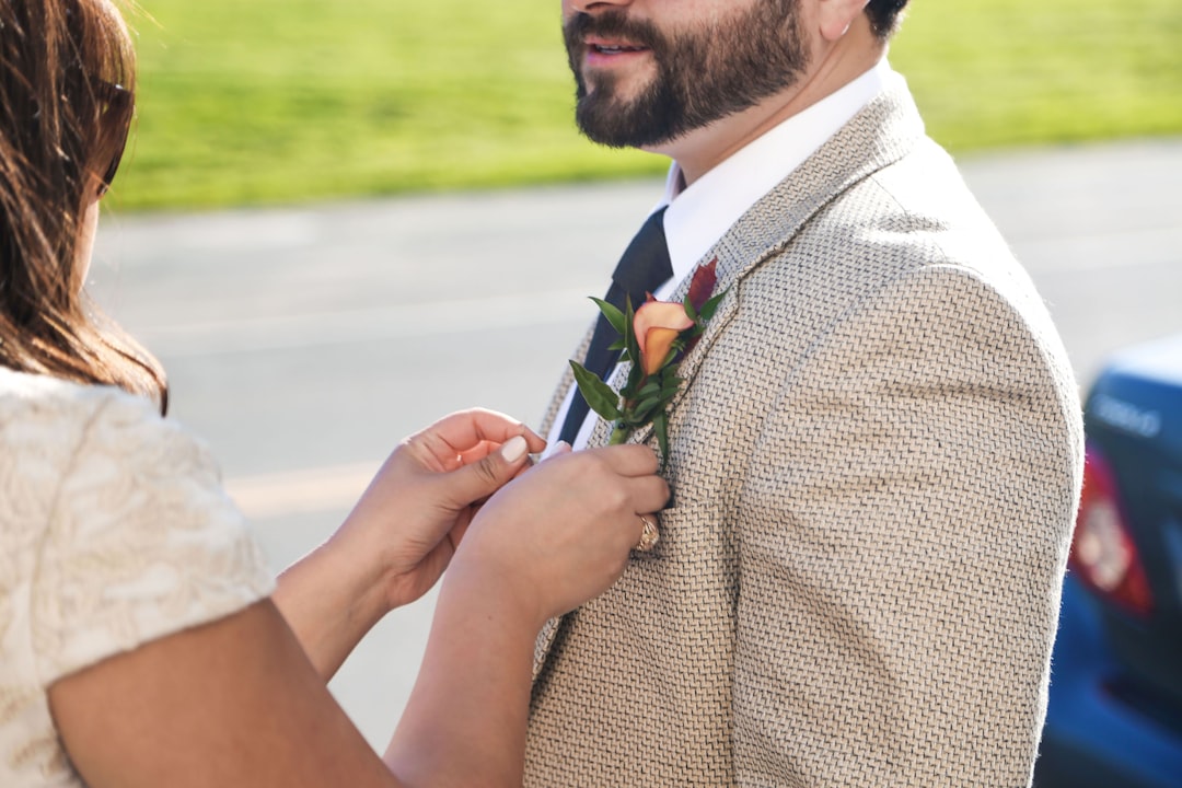 woman fixing man's blazer