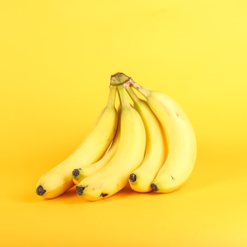 Bananas at different stages of ripeness arranged in a row