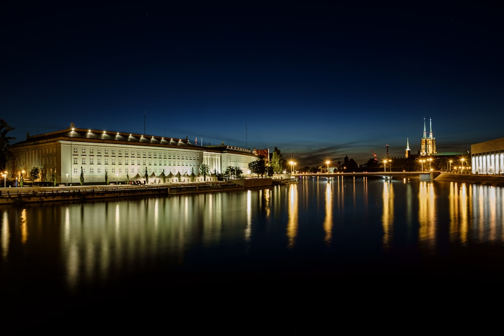 reflexo das luzes do edifício no corpo de água à noite