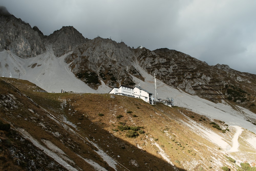 white concrete house beside mountain