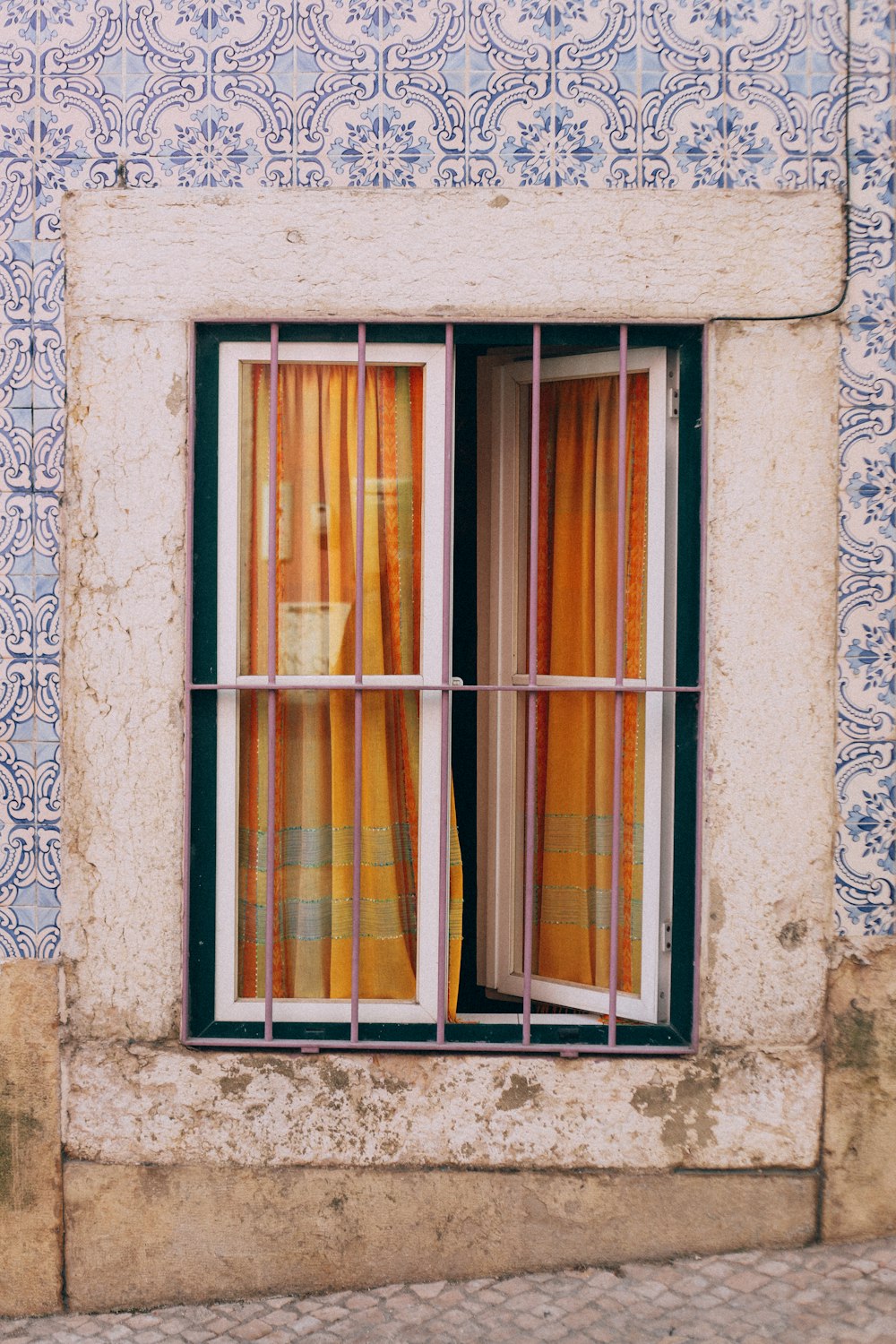 a window with a curtain and a window sill
