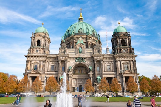 water fountain in front of gray concrete dome building in Lustgarten Germany