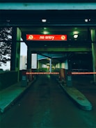 A fixed security barrier blocking a corporate parking entrance during peak hours