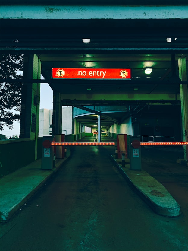Automatic car park barrier gate with red-white striped arm at the entrance of an office building basement car park in Kuala Lumpur