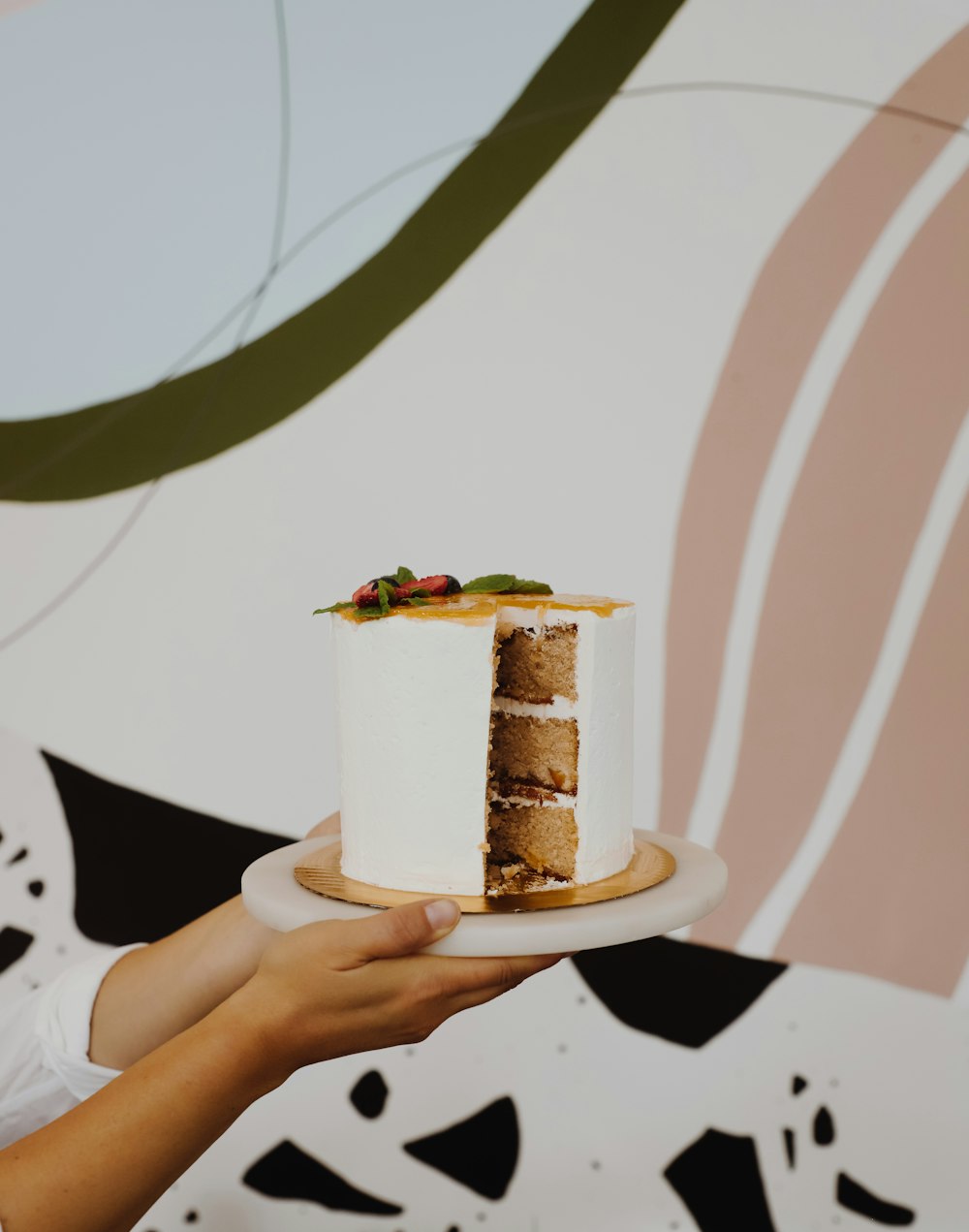 person holding plate with cake