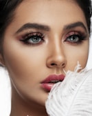 Dramatic mega volume lashes fanning out elegantly on a smiling client.