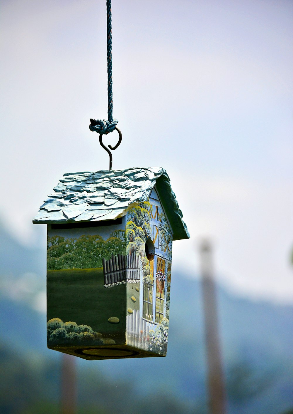 hanged black and blue bird nest during daytime