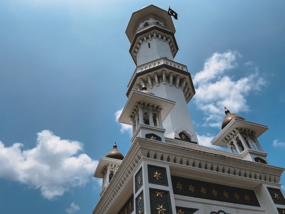 low-angle photography of white and brown tower