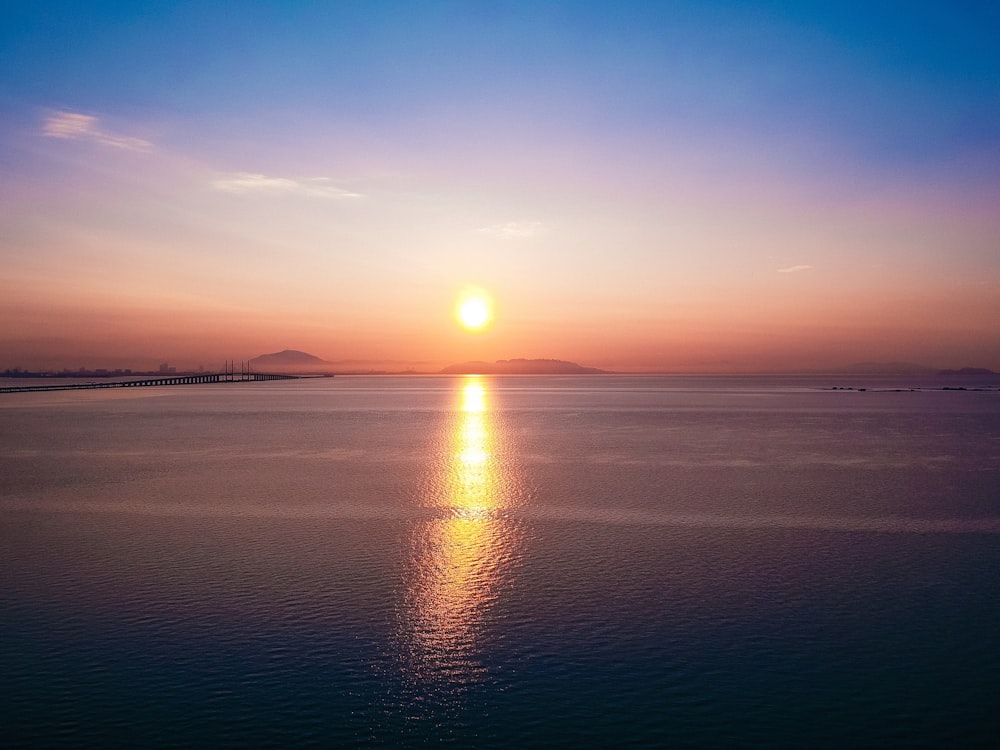 calm body of water during golden hour