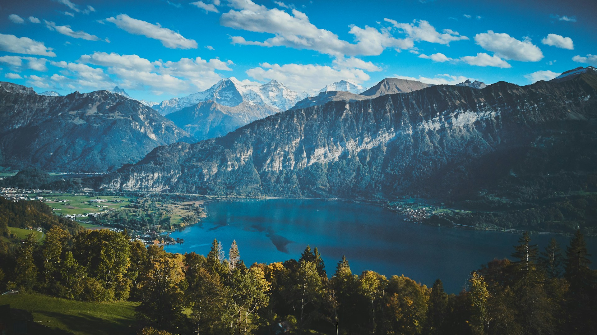 a scenic view of a lake surrounded by mountains