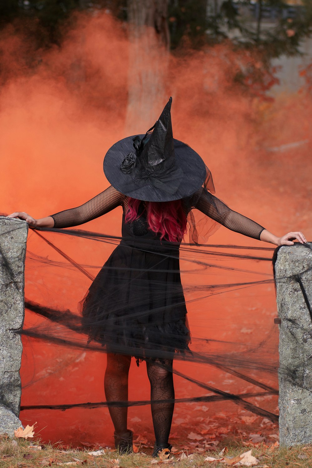 witch holding two black post