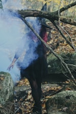 woman in witch costume standing beside rock